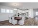 Bright dining room with wood table and white chairs, adjacent to kitchen at 257 Circle City Way, Pittsboro, NC 27312