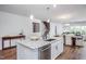 Kitchen island with sink, dishwasher, and view into adjoining dining area at 257 Circle City Way, Pittsboro, NC 27312