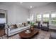 Cozy living room features a neutral sofa, armchairs, and a wood coffee table at 257 Circle City Way, Pittsboro, NC 27312
