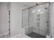 Spacious shower with marble surround and built-in bench seat at 257 Circle City Way, Pittsboro, NC 27312