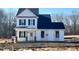 Two-story farmhouse style home with white siding and dark roof at 43 Olde Place Dr, Zebulon, NC 27597