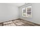 Bedroom with wood-look flooring and large windows offering plenty of natural light at 14 Stone Village Ct, Durham, NC 27704