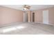 Large carpeted bedroom offering a ceiling fan, closet and view of ensuite bathroom at 14 Stone Village Ct, Durham, NC 27704