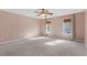 Spacious bedroom with wall-to-wall carpeting, with natural light, and a ceiling fan at 14 Stone Village Ct, Durham, NC 27704