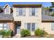 Charming two-story home with light-colored siding and grey shutters surrounded by landscaping and a small American flag at 14 Stone Village Ct, Durham, NC 27704