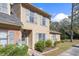 Two-story townhouse featuring well-manicured landscaping and a welcoming entrance at 14 Stone Village Ct, Durham, NC 27704