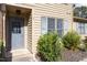 Front entrance showcasing the front door, window, and surrounding shrubbery at 14 Stone Village Ct, Durham, NC 27704