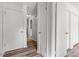 Hallway featuring wood-look flooring and white doors leading to other rooms in the home at 14 Stone Village Ct, Durham, NC 27704