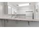 Kitchen with white appliances, cabinets, and countertop including a breakfast bar at 14 Stone Village Ct, Durham, NC 27704