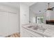 Bright kitchen featuring stainless steel sink and view into the living area with a fireplace at 14 Stone Village Ct, Durham, NC 27704