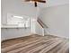 Open-concept living room with hardwood floors and a kitchen view, staircase, and an abundance of natural light at 14 Stone Village Ct, Durham, NC 27704