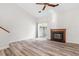 View of living room offering fireplace, sliding glass doors, ceiling fan and hardwood floors at 14 Stone Village Ct, Durham, NC 27704