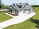 Three-car garage and an extended driveway add to the functionality of this well-manicured corner lot at 20 Water Willow Ln, Zebulon, NC 27597