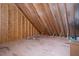 Unfinished attic with exposed wood beams and insulation at 20 Water Willow Ln, Zebulon, NC 27597