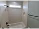Clean white tiled bathroom with tub and shower combination at 20 Water Willow Ln, Zebulon, NC 27597