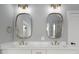 Modern bathroom featuring double vanities, quartz countertop, and bronze fixtures and hardware at 20 Water Willow Ln, Zebulon, NC 27597