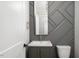 Stylish half bathroom featuring a modern vanity with decorative wall accents and a sleek mirror at 20 Water Willow Ln, Zebulon, NC 27597