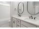 Bathroom featuring double vanities with modern fixtures and a separate area for toilet and shower at 20 Water Willow Ln, Zebulon, NC 27597
