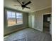 Bedroom with ceiling fan and large window showcasing a view, adjoining bathroom at 20 Water Willow Ln, Zebulon, NC 27597