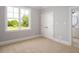 Bright bedroom featuring neutral walls, carpet floors, closet and a large window with beautiful backyard views at 20 Water Willow Ln, Zebulon, NC 27597