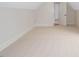 Unfinished bonus room featuring carpet, sloped ceilings, natural light and an adjacent room at 20 Water Willow Ln, Zebulon, NC 27597