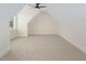 Finished bonus room with carpet, sloped ceilings, and natural light from the window at 20 Water Willow Ln, Zebulon, NC 27597