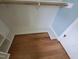 Walk-in closet with hardwood floors, shelves, and clothing rod at 20 Water Willow Ln, Zebulon, NC 27597