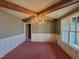 Bright dining room features wood beam ceiling, wainscoting and a modern chandelier at 20 Water Willow Ln, Zebulon, NC 27597