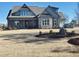 Two-story house with gray siding, stone accents, and a covered porch at 20 Water Willow Ln, Zebulon, NC 27597