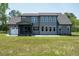 Back of house with large windows, screened porch and attached garage at 20 Water Willow Ln, Zebulon, NC 27597