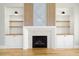 Close-up view of a fireplace with built-in shelves and cabinet space with hardwood floors at 20 Water Willow Ln, Zebulon, NC 27597