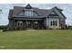 Beautiful single-Gathering home featuring a well-manicured lawn and a combination of stone and siding accents at 20 Water Willow Ln, Zebulon, NC 27597