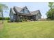 Well-designed home with a covered porch, wood accents, and stone detailing, set on a green lawn at 20 Water Willow Ln, Zebulon, NC 27597