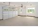 Spacious garage featuring a large door with windows, clean concrete floors, and natural light at 20 Water Willow Ln, Zebulon, NC 27597