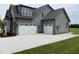 Spacious three car garage providing ample parking, with carriage doors and a wide driveway at 20 Water Willow Ln, Zebulon, NC 27597