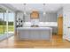Modern kitchen featuring a large island, gray cabinets, stainless steel appliances and hardwood floors at 20 Water Willow Ln, Zebulon, NC 27597