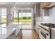 Bright kitchen featuring a farmhouse sink, stainless steel appliances, gas range, and lots of natural light at 20 Water Willow Ln, Zebulon, NC 27597