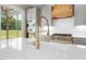 Bright, modern kitchen featuring a large island, stainless steel appliances, and an open view to the backyard at 20 Water Willow Ln, Zebulon, NC 27597