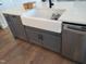 Farmhouse style kitchen sink with white countertops and modern gray cabinets at 20 Water Willow Ln, Zebulon, NC 27597