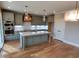 Modern kitchen featuring grey cabinets, stainless steel appliances, quartz countertops, and a large center island at 20 Water Willow Ln, Zebulon, NC 27597