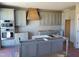 Modern kitchen with gray cabinets, wooden range hood, and island at 20 Water Willow Ln, Zebulon, NC 27597