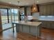Spacious kitchen with an island, stainless steel appliances, pantry, and pendant lighting at 20 Water Willow Ln, Zebulon, NC 27597