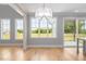 Living room filled with natural light, showcasing large windows and sliding glass doors leading to a patio at 20 Water Willow Ln, Zebulon, NC 27597