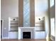Bright living room with fireplace, built-in shelves, hardwood floors, and soaring ceilings at 20 Water Willow Ln, Zebulon, NC 27597