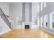 Bright living room featuring a fireplace, built-in shelves, and lots of natural light from large windows at 20 Water Willow Ln, Zebulon, NC 27597
