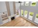 Open concept living room featuring a fireplace, hardwood floors, and many windows at 20 Water Willow Ln, Zebulon, NC 27597