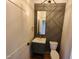 Stylish powder room with modern vanity, gold accents, and decorative wall feature at 20 Water Willow Ln, Zebulon, NC 27597