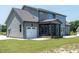 Home's backyard featuring a screened-in porch, attached garage, and meticulously maintained lawn at 20 Water Willow Ln, Zebulon, NC 27597