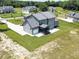 Aerial view of home with attached garage, screened in porch, and spacious, manicured yard at 20 Water Willow Ln, Zebulon, NC 27597