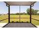 Screened porch with views of a large backyard and trees at 20 Water Willow Ln, Zebulon, NC 27597